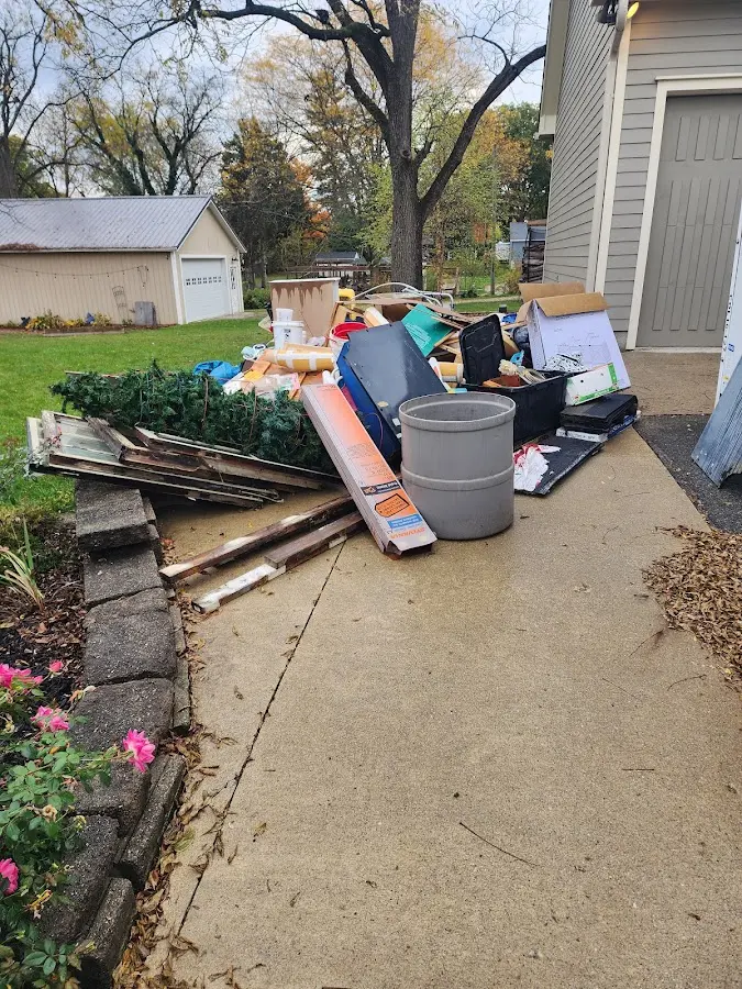 Dumpster being loaded with debris for Estate Cleanout Dumpster Rental in Osage